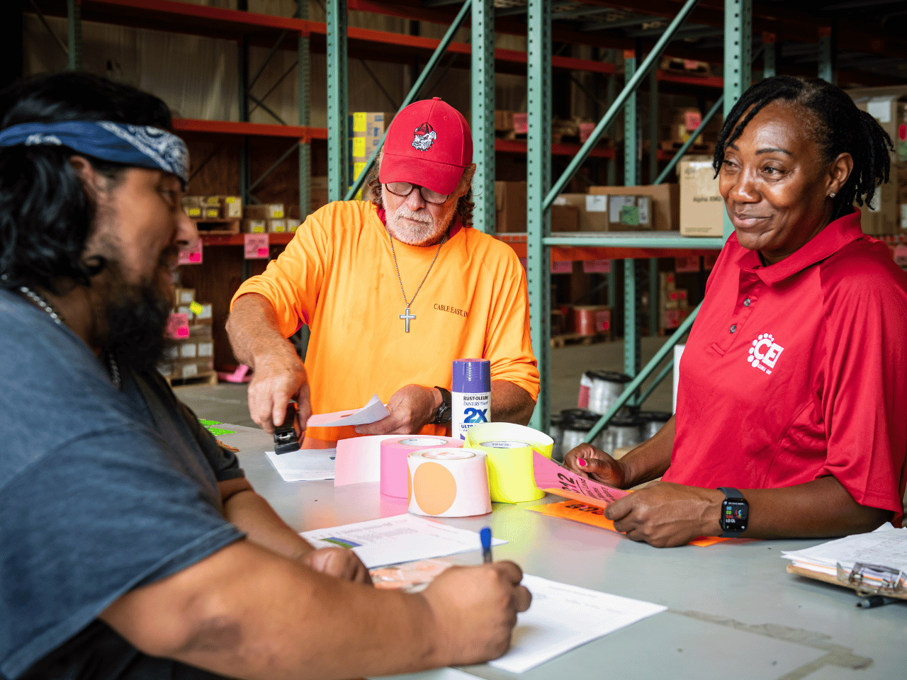 CEI Employee Groups Cable East team members work together at a table.